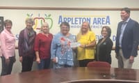 Neighborhood group presents check to help AASD with debt post image